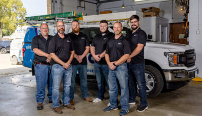 CLtel technicians standing in garage.